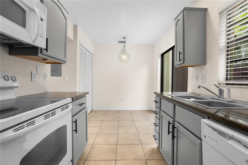 7337 Cedar Creek Court, Unit 75 Winter Park, FL 32792 - Photo 3 of 26 a kitchen with a sink stove and cabinets
