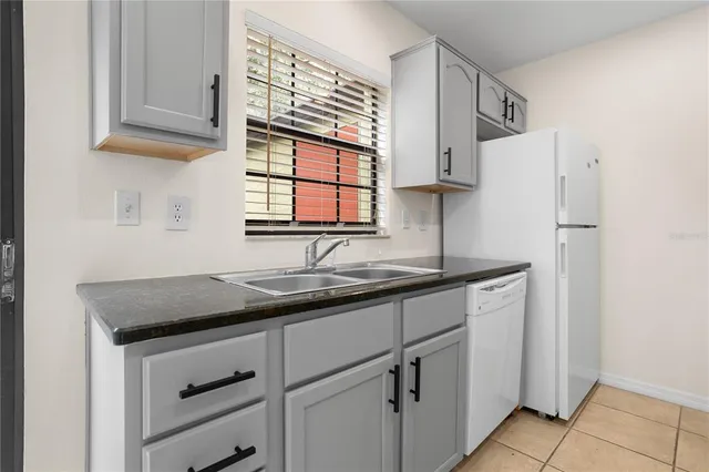 a kitchen with stainless steel appliances granite countertop a sink and a cabinets