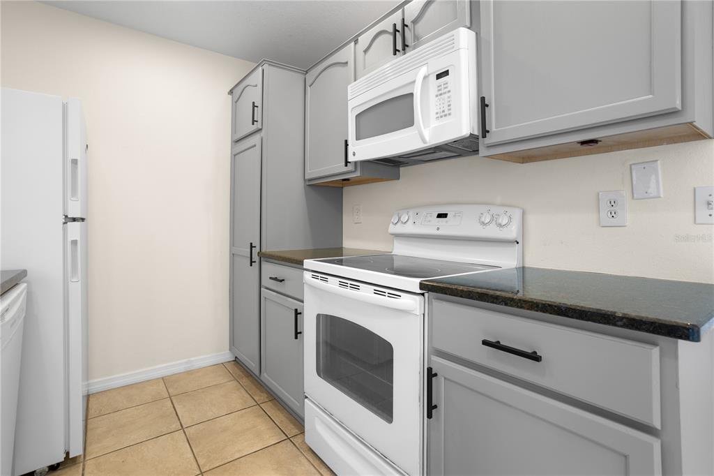 7337 Cedar Creek Court, Unit 75 Winter Park, FL 32792 - Photo 5 of 26 a view of a kitchen with white cabinets