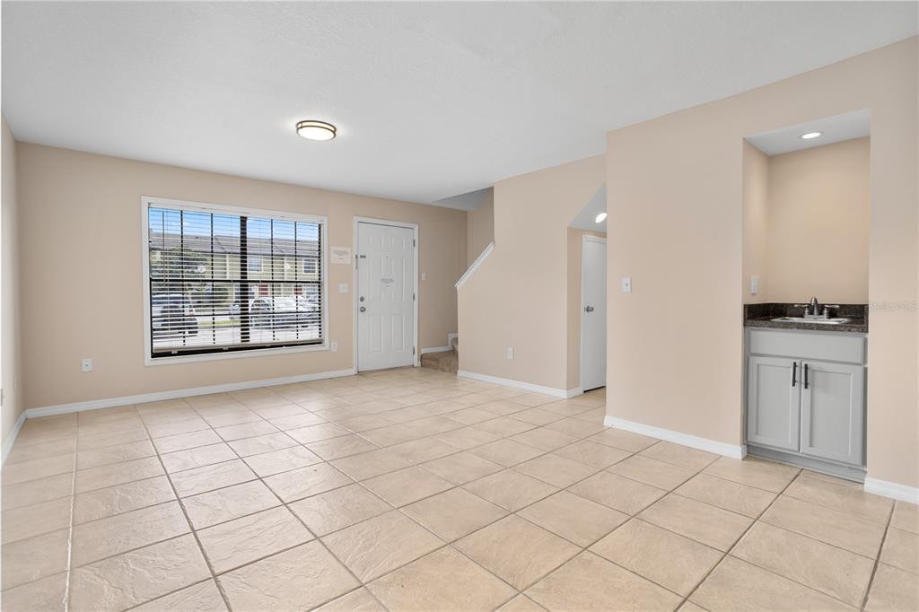 7337 Cedar Creek Court, Unit 75 Winter Park, FL 32792 - Photo 6 of 26 an empty room with kitchen and window