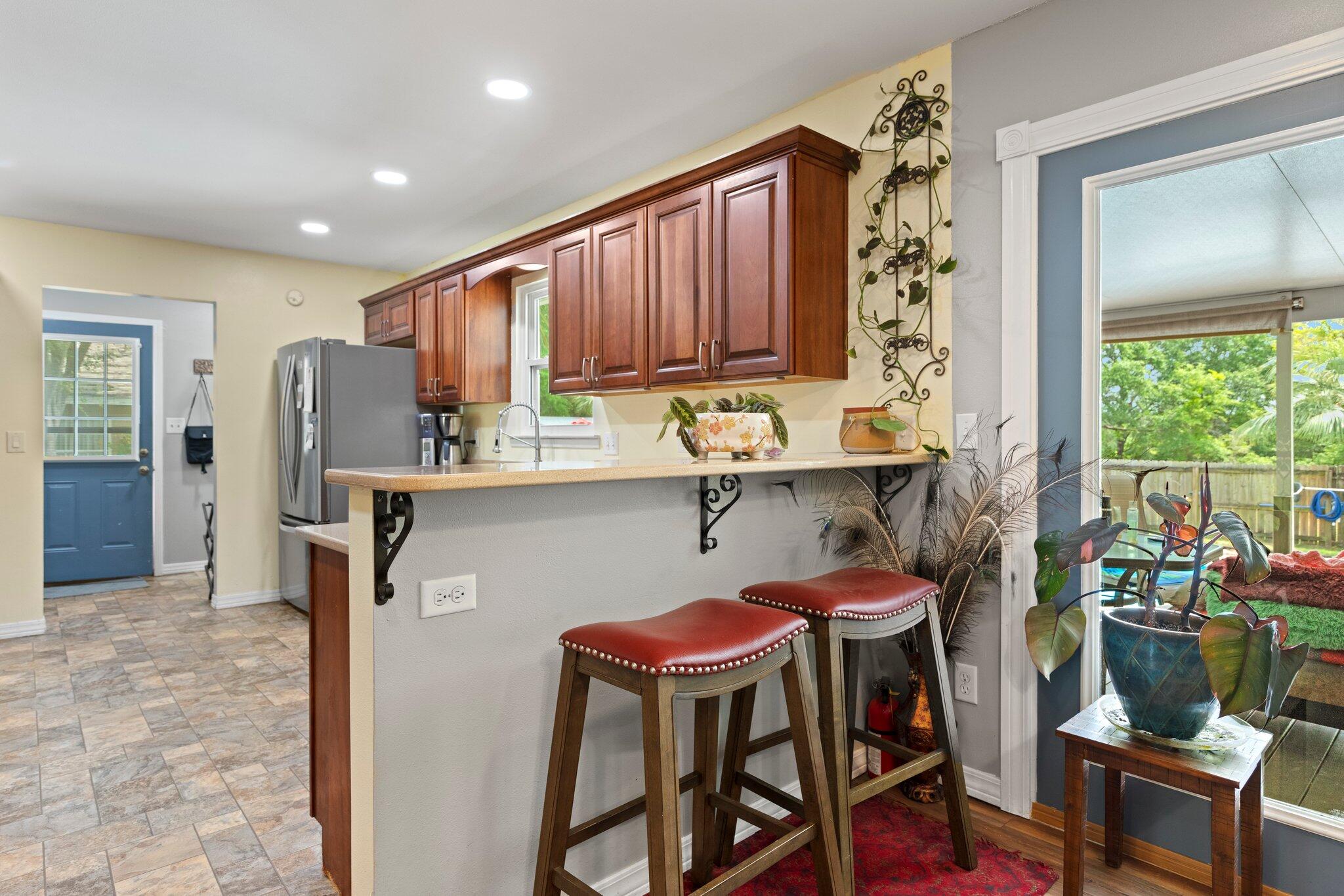 1120 Tallokas Road Crestview, FL 32536 - Photo 13 of 55 a kitchen with stainless steel appliances granite countertop a table chairs and a refrigerator