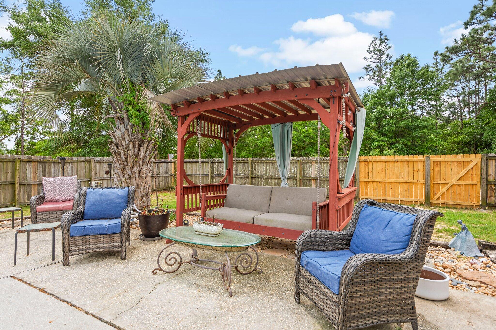1120 Tallokas Road Crestview, FL 32536 - Photo 33 of 55 a view of a patio with couches chairs and a potted plant