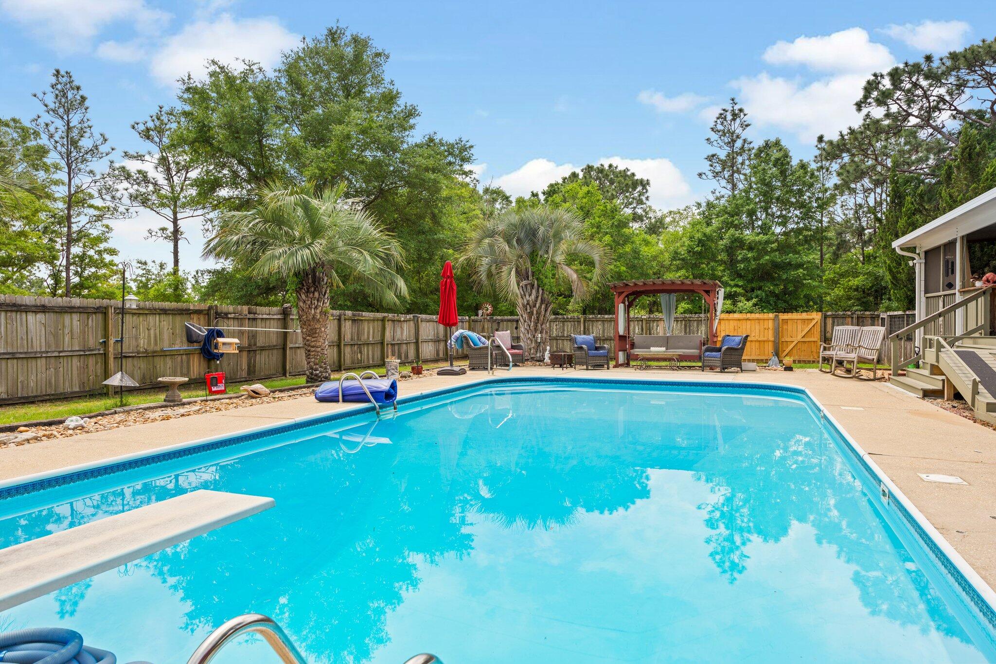 1120 Tallokas Road Crestview, FL 32536 - Photo 39 of 55 a view of a swimming pool with an outdoor seating