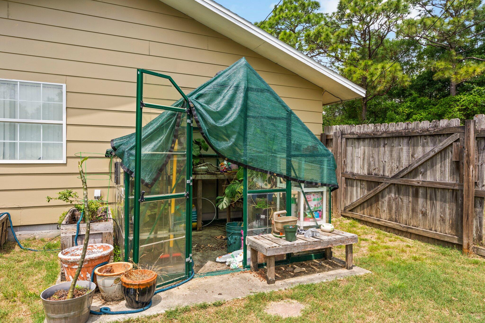 1120 Tallokas Road Crestview, FL 32536 - Photo 40 of 55 a backyard of a house with table and chairs