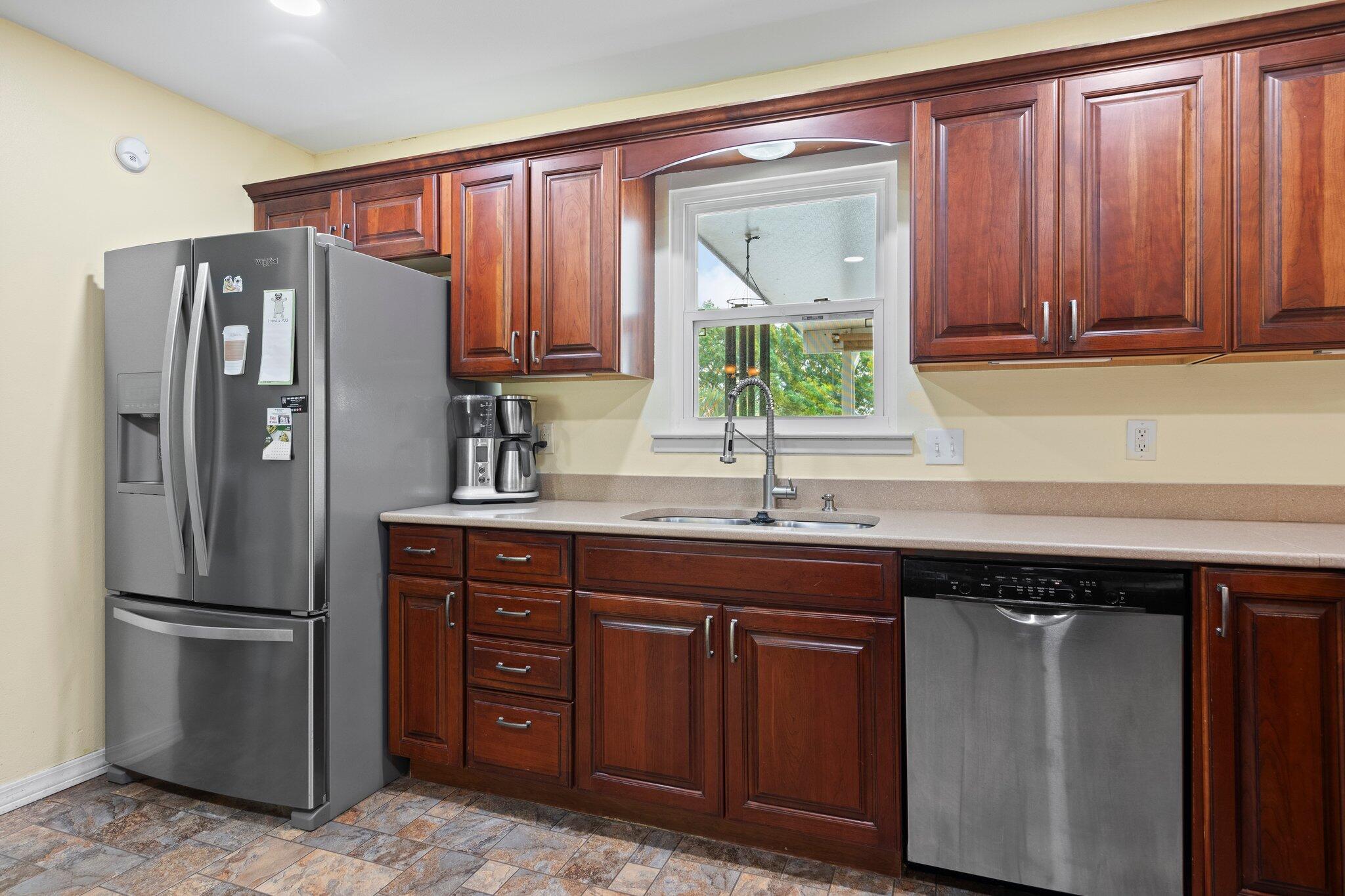 1120 Tallokas Road Crestview, FL 32536 - Photo 4 of 55 a kitchen with stainless steel appliances granite countertop a refrigerator and a sink
