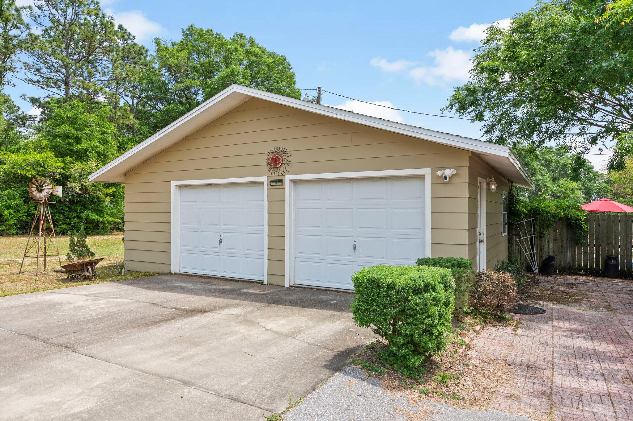 1120 Tallokas Road Crestview, FL 32536 - Photo 51 of 55 a view of a house with a yard and garage