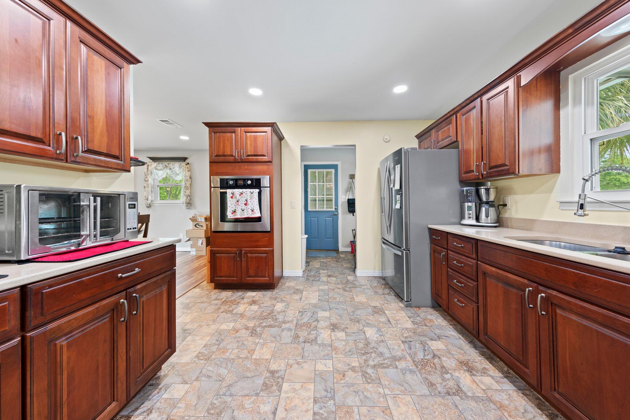 1120 Tallokas Road Crestview, FL 32536 - Photo 6 of 55 a kitchen with stainless steel appliances granite countertop a refrigerator and a sink