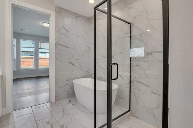 a spacious bathroom with a bathtub shower sink and toilet