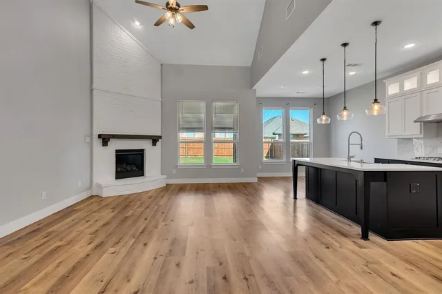 a view of an empty room window and wooden floor
