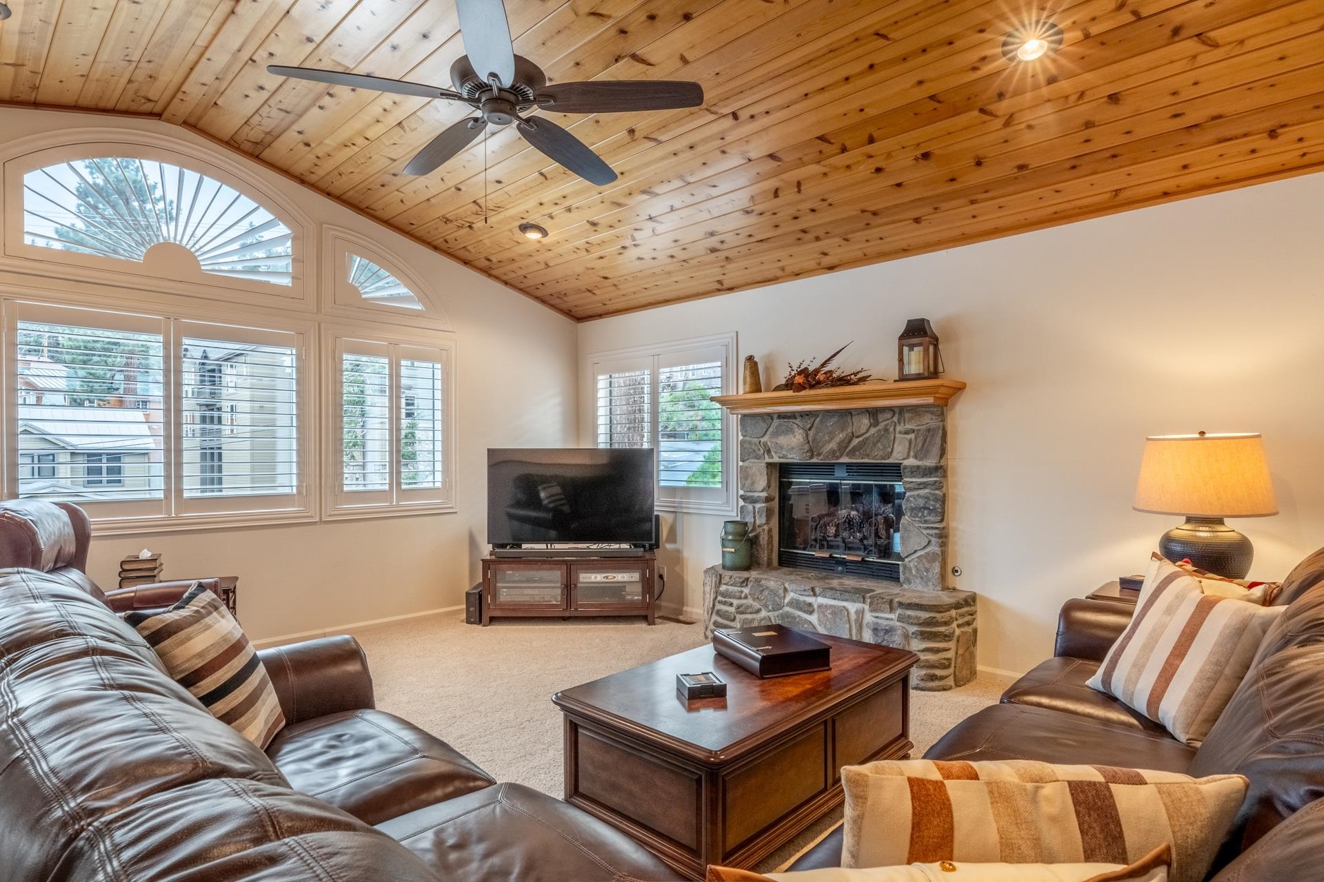 236 Davison Road Mammoth Lakes, CA 93546 - Photo 2 of 49 a living room with furniture a fireplace and a flat screen tv
