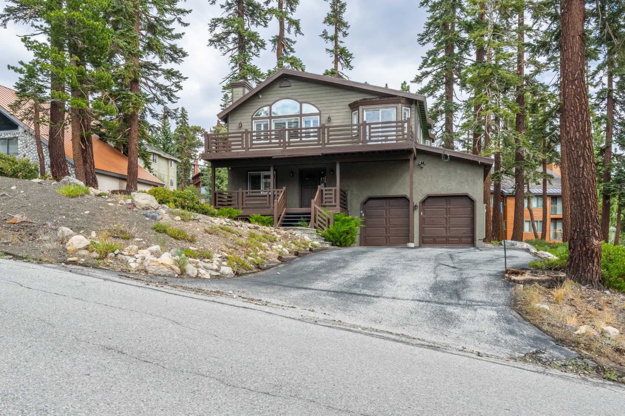 236 Davison Road Mammoth Lakes, CA 93546 - Photo 43 of 49 a front view of a house with a garden and garage