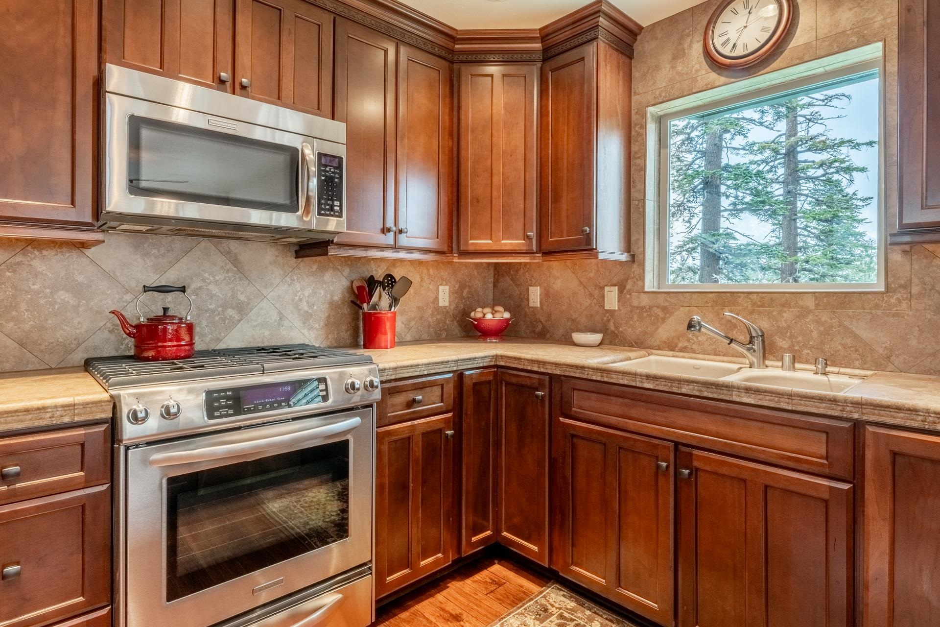 236 Davison Road Mammoth Lakes, CA 93546 - Photo 9 of 49 a kitchen with stainless steel appliances granite countertop a stove a microwave a sink and cabinets