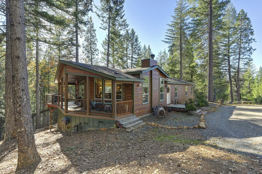 a view of a house with a yard and sitting area