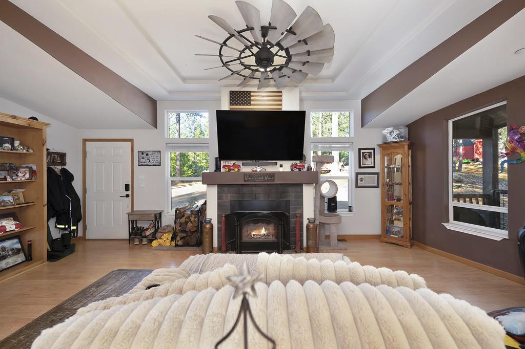 5060 Chestnut Court Georgetown, CA 95634 - Photo 21 of 65 a living room with furniture a flat screen tv and a fireplace