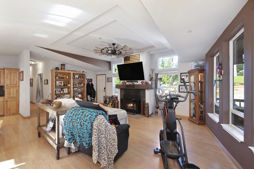5060 Chestnut Court Georgetown, CA 95634 - Photo 22 of 65 a living room with furniture a flat screen tv and a floor to ceiling window