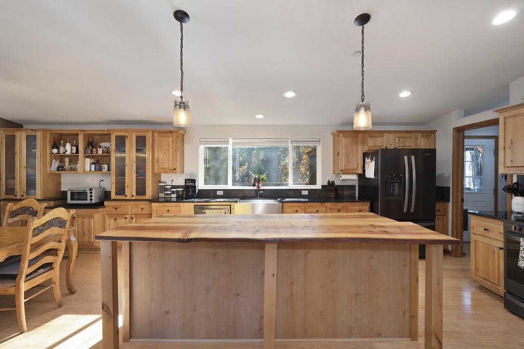 5060 Chestnut Court Georgetown, CA 95634 - Photo 28 of 65 a view of a kitchen with stainless steel appliances granite countertop a refrigerator a oven and a sink with granite countertops
