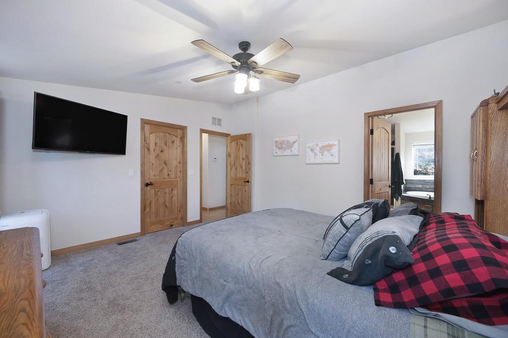 5060 Chestnut Court Georgetown, CA 95634 - Photo 45 of 65 a bedroom with a large bed and a flat screen tv
