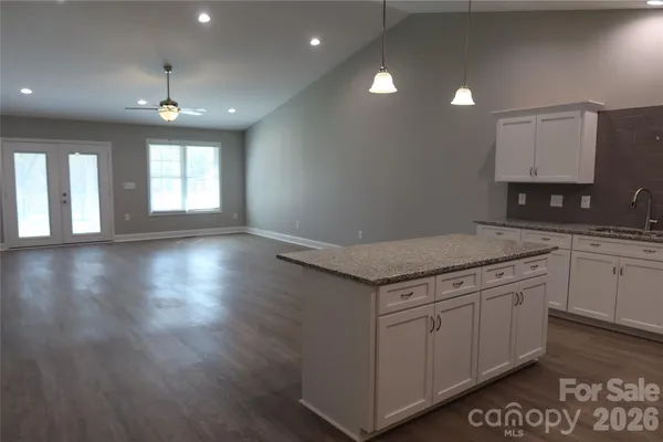 a kitchen that has a sink and a stove in it