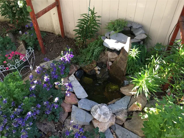 a backyard of a house with a yard and outdoor seating
