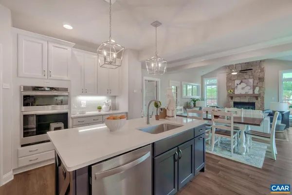 a kitchen with sink cabinets and wooden floor