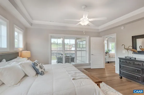a bedroom with a large bed and flat tv