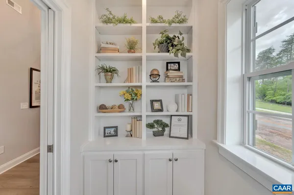 a shelf with books and knick knacks on it