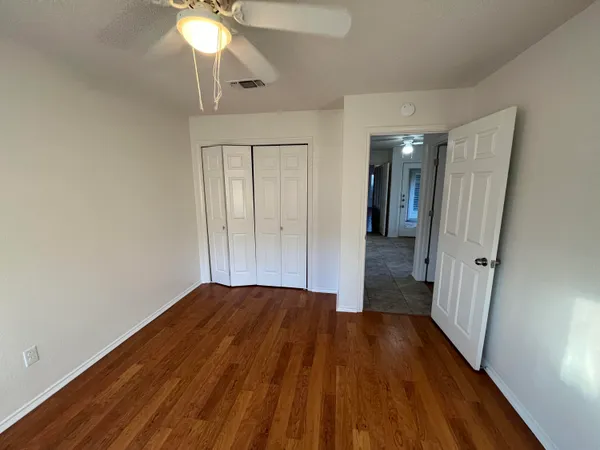 a view of a hallway with wooden floor