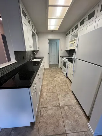 a kitchen with a sink a refrigerator and a stove