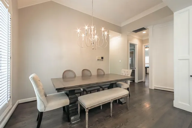 a dining room with furniture and chandelier