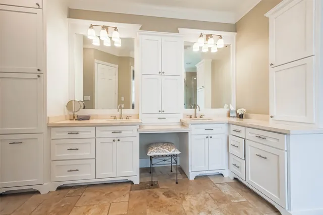 a spacious bathroom with a double vanity sink mirror and