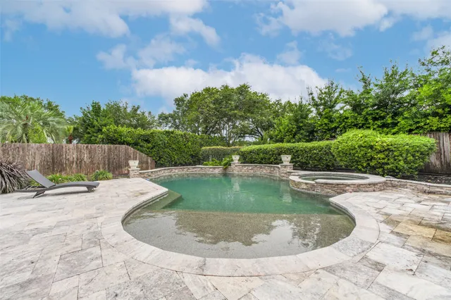 a view of a swimming pool with a yard
