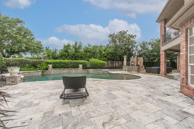 a view of a fountain with a bench in the patio