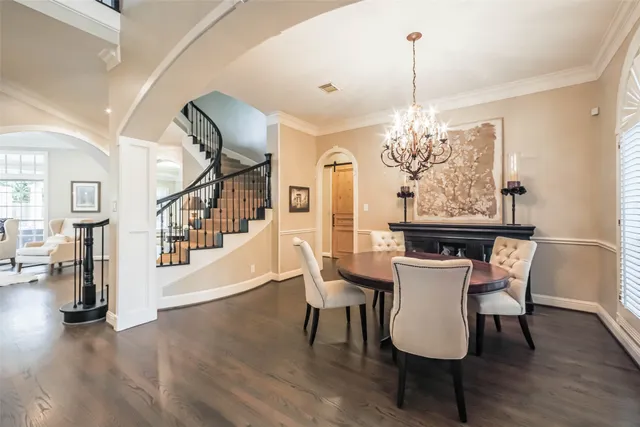 a view of a dining room with furniture wooden floor and chandelier