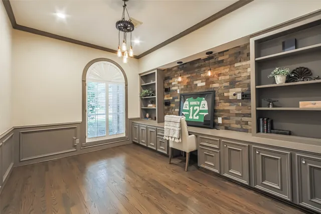 a very nice looking room with wooden floor and furniture