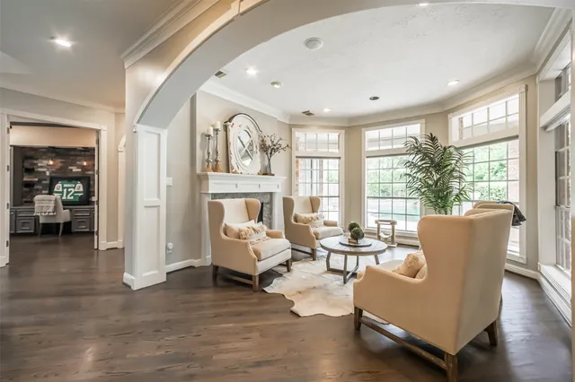 a living room with furniture and large windows