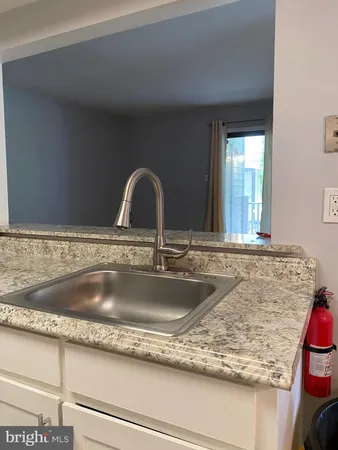 a kitchen with stainless steel appliances granite countertop a stove and a refrigerator