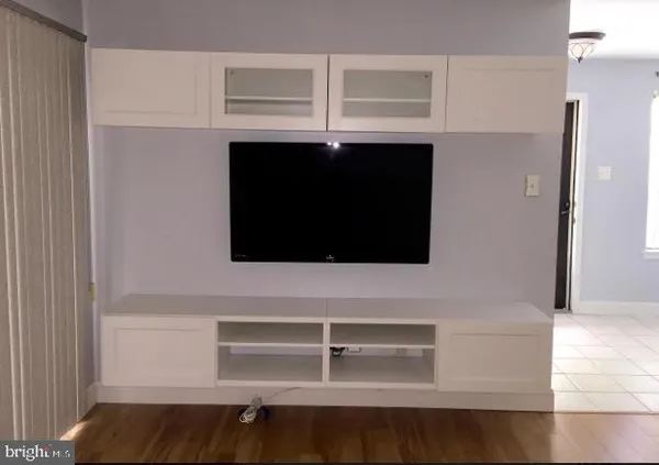 a view of a room with wooden floor and window