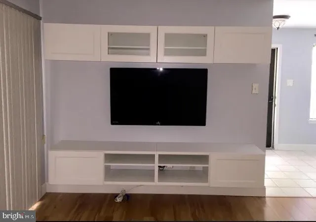 a view of a room with wooden floor and window