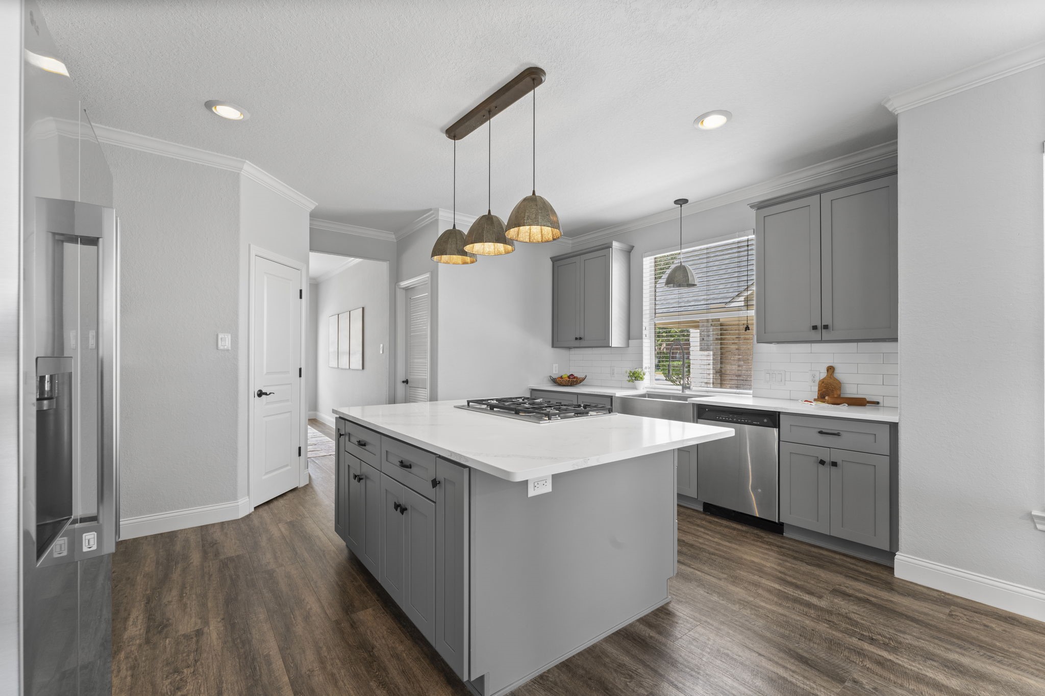 19218 Country Village Drive Spring, TX 77388 - Photo 11 of 30 a kitchen with a sink stove and wooden cabinets