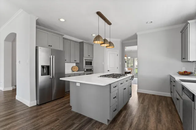 a kitchen with wooden floor and white appliances
