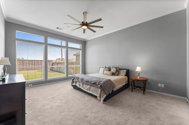 a spacious bedroom with a bed and a chandelier