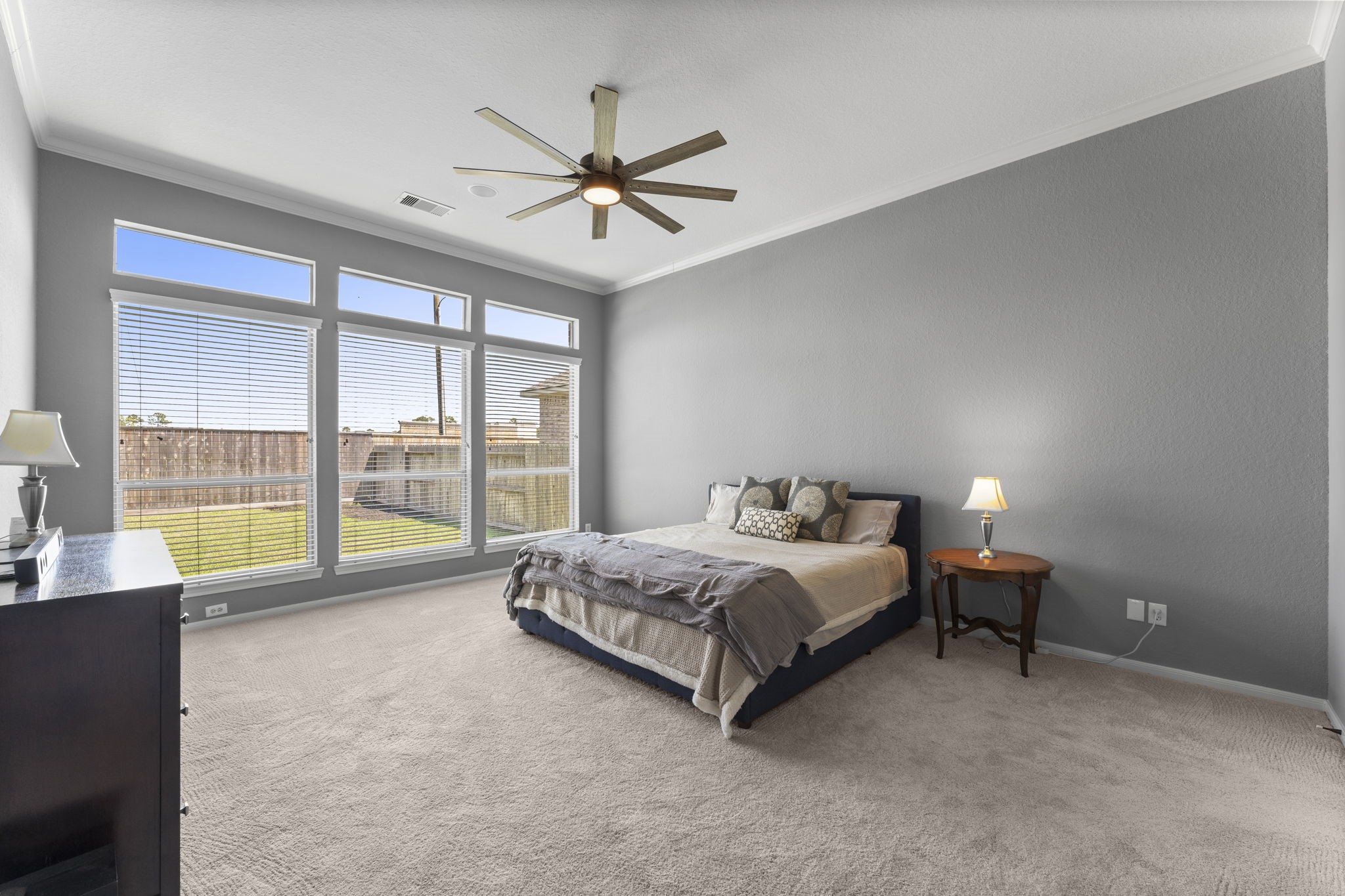 19218 Country Village Drive Spring, TX 77388 - Photo 16 of 30 a spacious bedroom with a bed and a chandelier