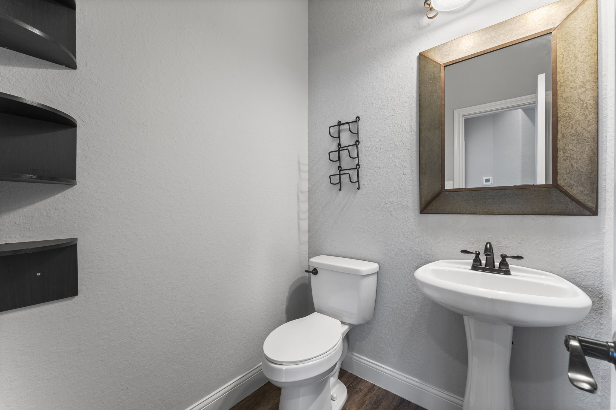 19218 Country Village Drive Spring, TX 77388 - Photo 25 of 30 a bathroom with a toilet a sink and mirror