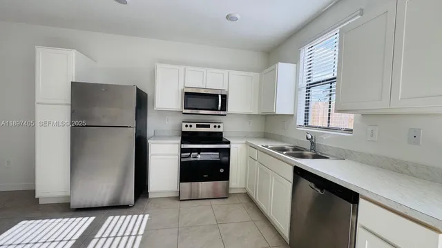 a kitchen with a refrigerator sink and stove