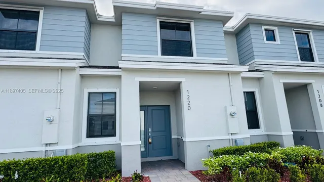 a view of a house with potted plants