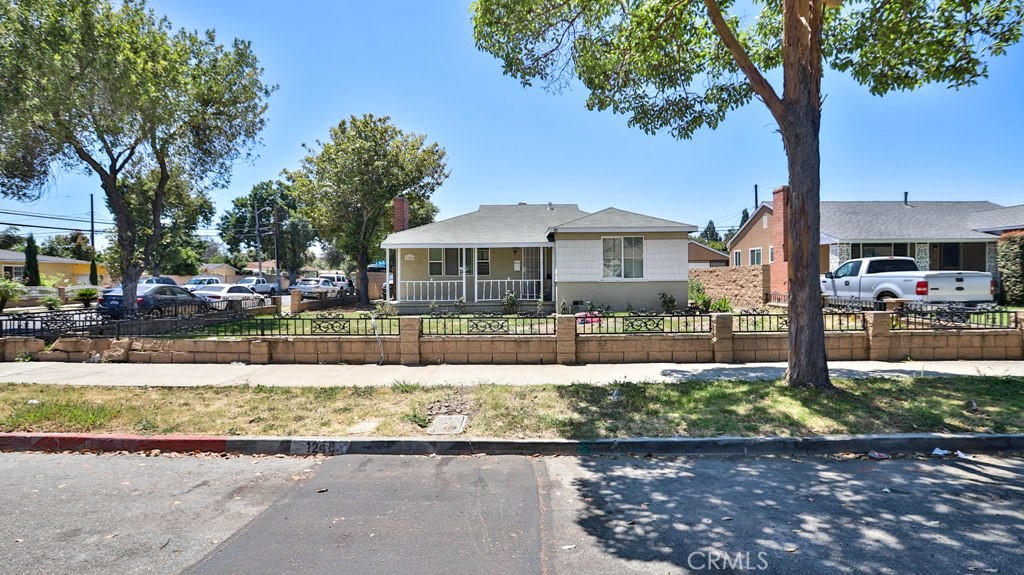 a front view of a house with a yard and a garden