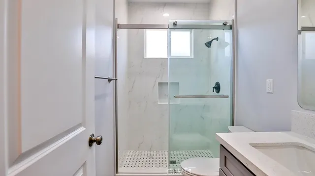 a view of a bathroom from a corridor