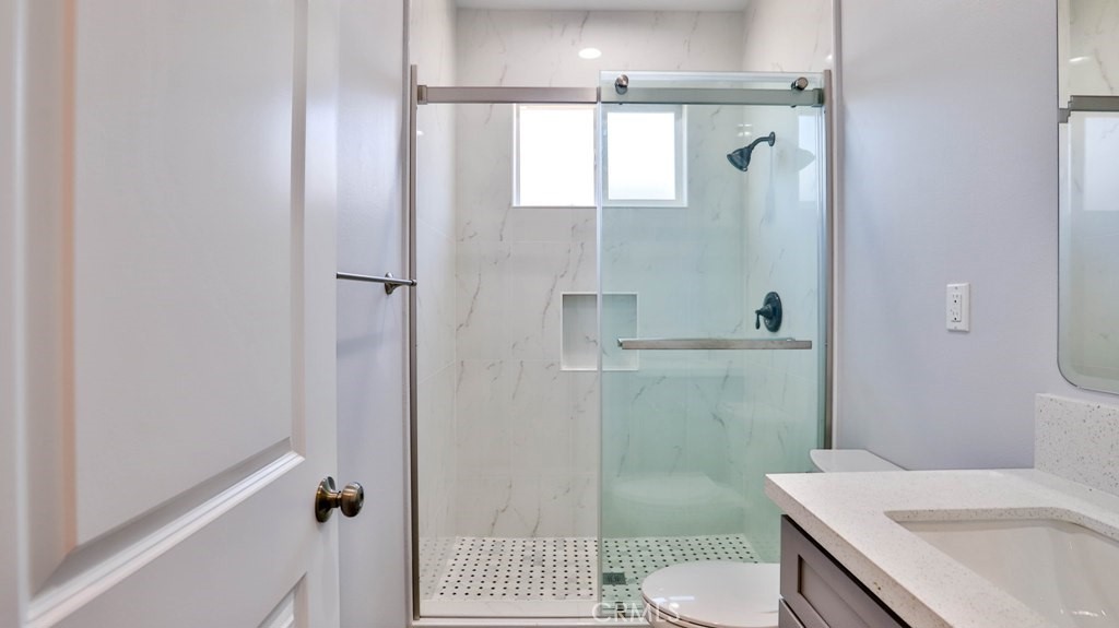 1246 South Baker Street Santa Ana, CA 92707 - Photo 12 of 19 a bathroom with a sink toilet and shower