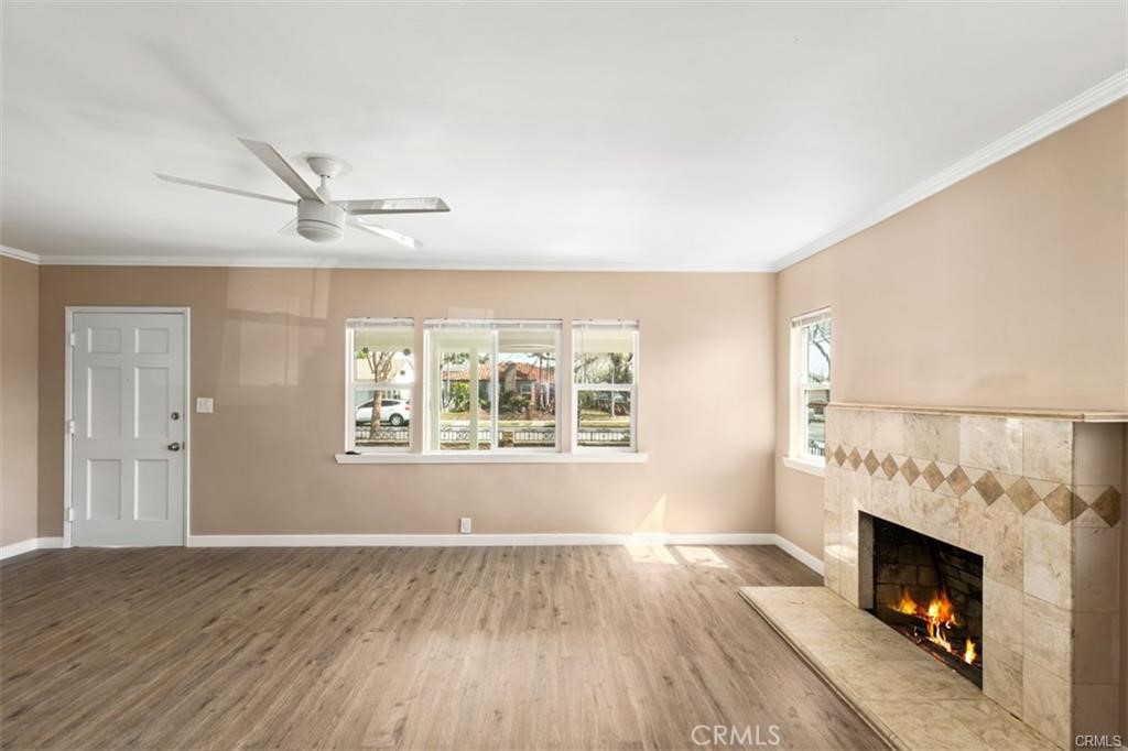 1246 South Baker Street Santa Ana, CA 92707 - Photo 15 of 19 a view of an empty room with wooden floor fireplace and a window