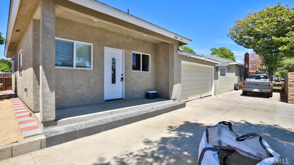 1246 South Baker Street Santa Ana, CA 92707 - Photo 4 of 19 a front view of a house with cars